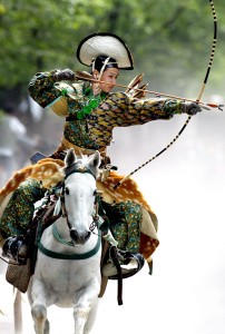 An archer in ancient samurai warrior uniform ridin